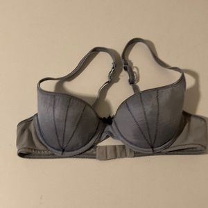Blue bra with black decorative zigzag stitching.